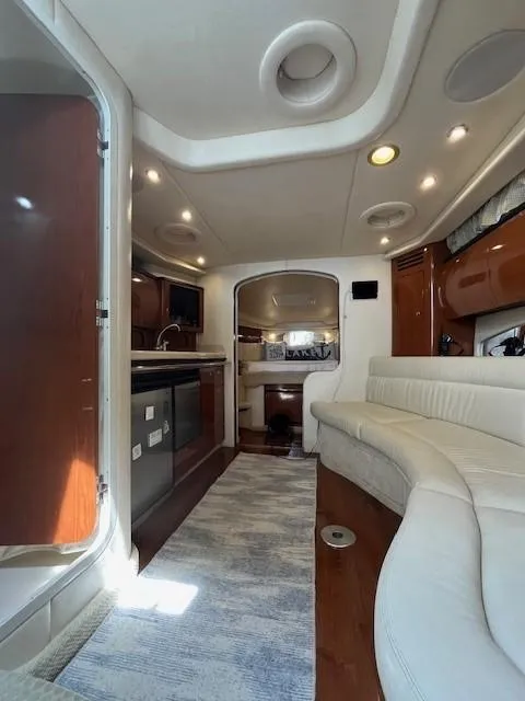 Slide: The Image of Interior of 2002 Sea Ray 360 Sundancer yacht with modern kitchen and cozy seating area. - 23