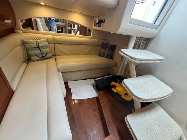 Slide: The Image of Interior of 2002 Sea Ray 360 Sundancer with cream leather seating and wooden flooring. - 25