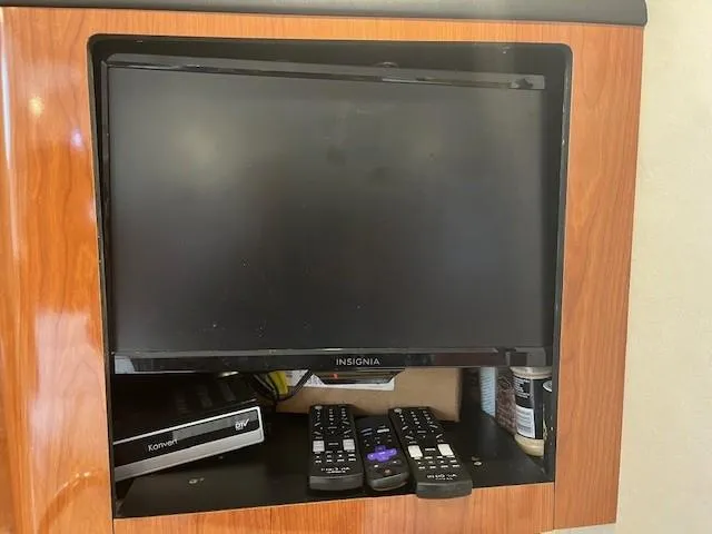 Slide: The Image of Insignia TV with remotes in a 2002 Sea Ray 360 Sundancer boat. - 27