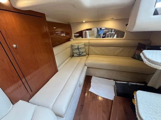 Slide: The Image of Interior of 2002 Sea Ray 360 Sundancer with beige seating and wooden cabinetry. - 38