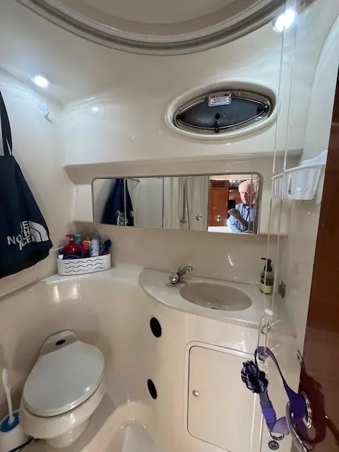 Slide: The Image of 2002 Sea Ray 360 Sundancer bathroom with sink, toilet, and mirror. - 40