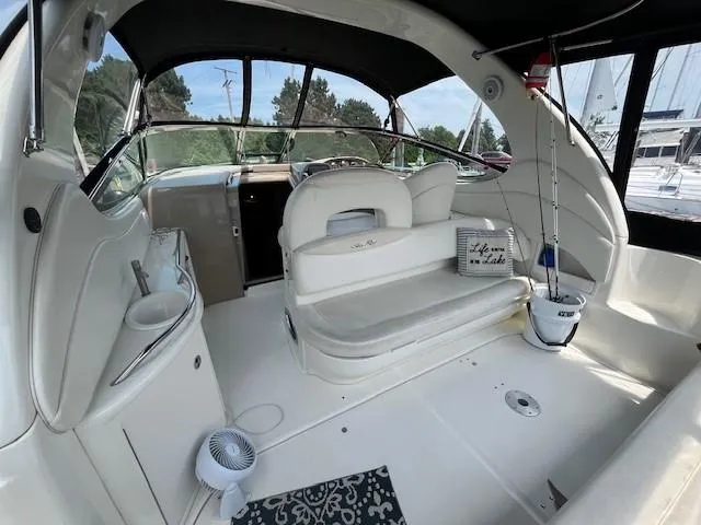 Slide: The Image of 2002 Sea Ray 360 Sundancer interior with seating and helm station. - 8