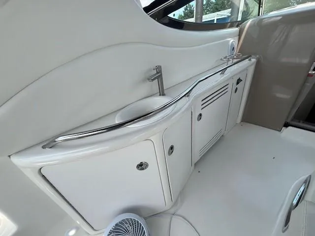 Slide: The Image of Sea Ray 360 Sundancer 2002 boat interior with sink and storage cabinets. - 9