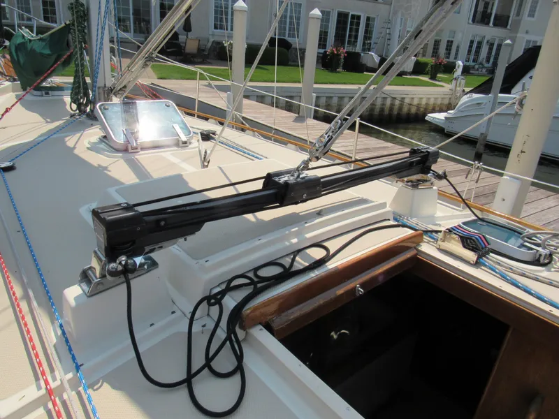 Slide: The Image of 1987 Island Packet 31 sailboat deck with rigging and open hatch in marina setting. - 13