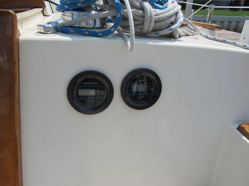 Slide: The Image of 1987 Island Packet 31 sailboat cockpit with gauges and coiled ropes. - 5