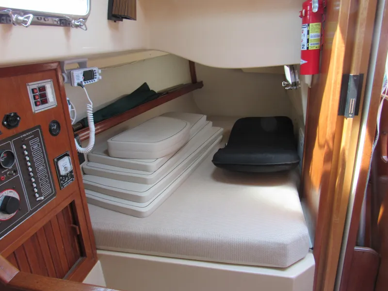 Slide: The Image of Interior cabin of 1987 Island Packet 31 sailboat with cushions and control panel. - 7