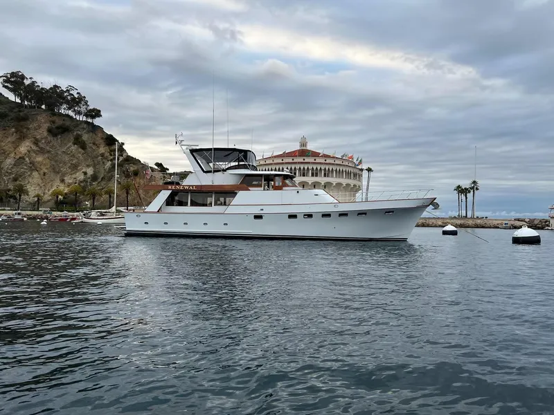 Slide: The Image of 1976 Nordlund 60 Motoryacht anchored near scenic coastal landscape. - 1
