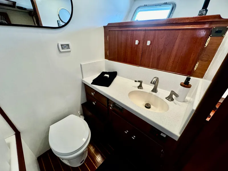 Slide: The Image of Bathroom interior of 1976 Nordlund 60 Motoryacht with wooden cabinetry and modern fixtures. - 15