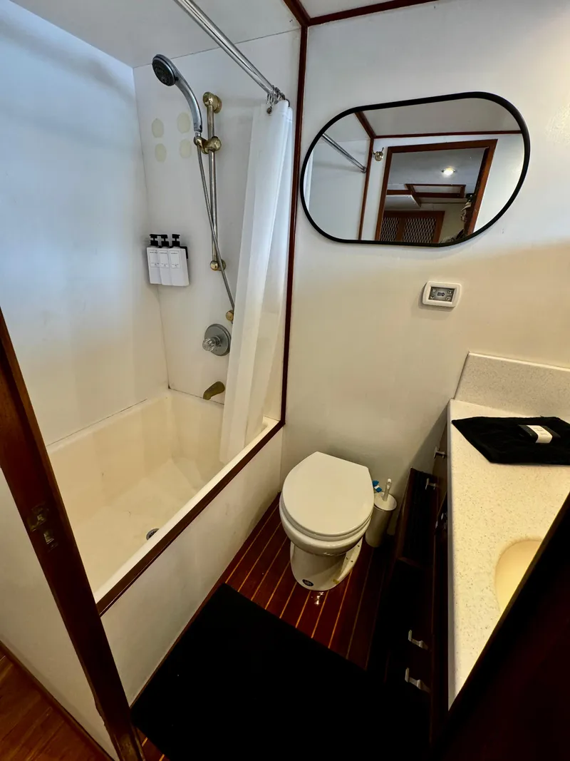 Slide: The Image of Bathroom interior of a 1976 Nordlund 60 Motoryacht with shower, toilet, and vanity. - 16