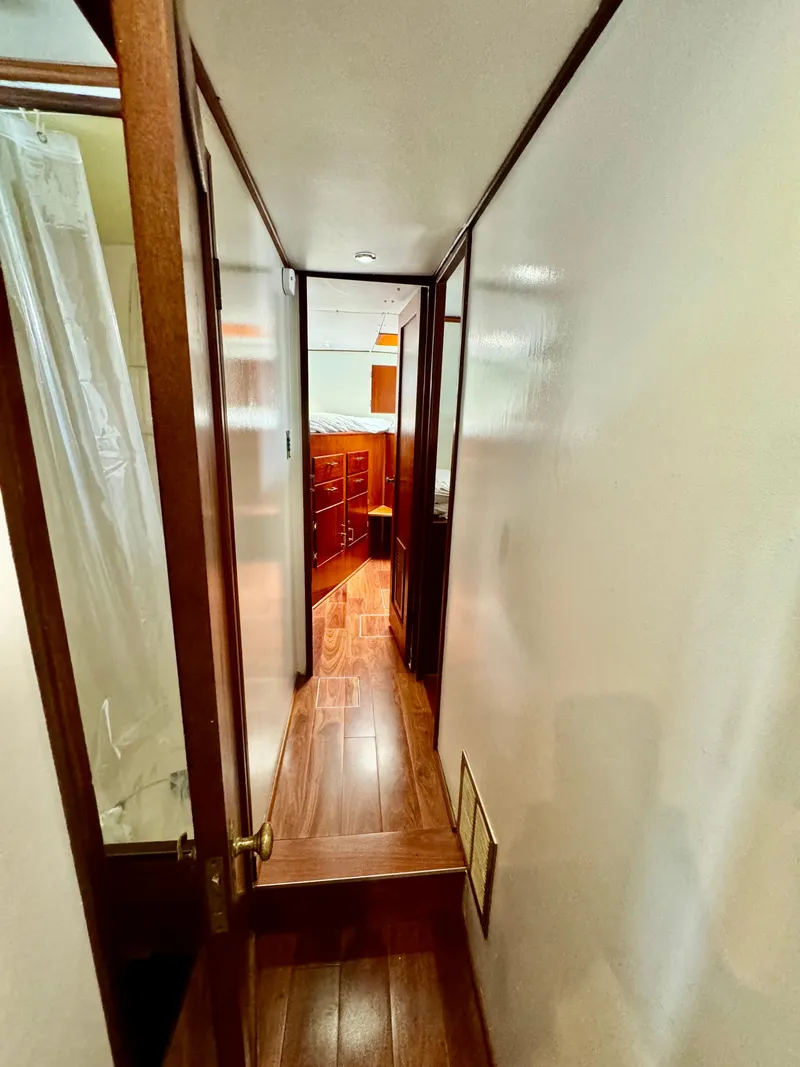 Slide: The Image of Hallway inside 1976 Nordlund 60 Motoryacht with wooden flooring and white walls. - 17