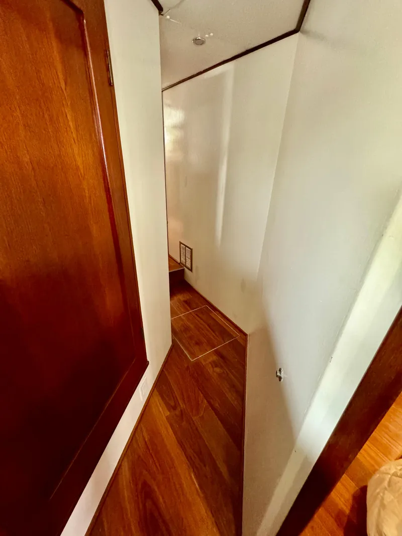 Slide: The Image of Narrow hallway with wooden flooring inside a 1976 Nordlund 60 Motoryacht. - 19