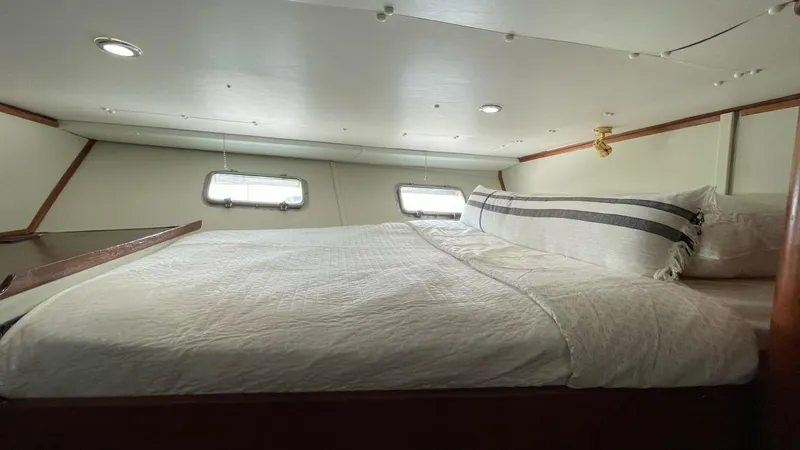 Slide: The Image of 1976 Nordlund 60 Motoryacht cabin with cozy bed and porthole windows. - 20