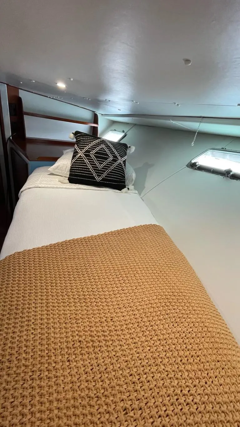 Slide: The Image of Cozy cabin bed in 1976 Nordlund 60 Motoryacht with decorative pillows and blanket. - 23