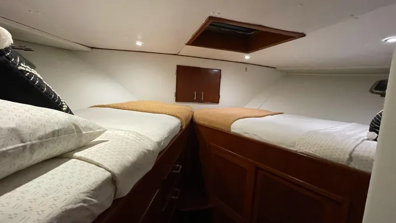 Slide: The Image of Cabin interior of a 1976 Nordlund 60 Motoryacht with twin beds and wooden cabinetry. - 25
