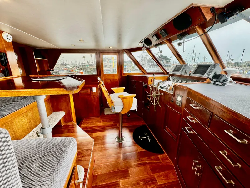 Slide: The Image of 1976 Nordlund 60 Motoryacht interior with wooden finishes and helm station. - 28