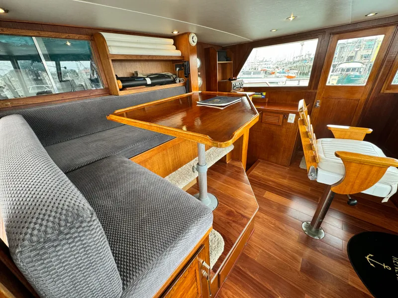 Slide: The Image of Interior of a 1976 Nordlund 60 Motoryacht with wooden furnishings and seating area. - 29