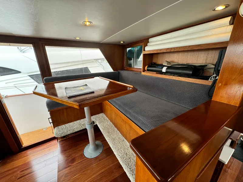 Slide: The Image of Interior of 1976 Nordlund 60 Motoryacht with wooden table and seating area. - 33