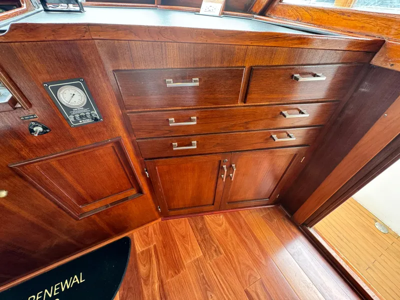 Slide: The Image of Wooden cabinetry inside a 1976 Nordlund 60 Motoryacht, featuring drawers and a gauge. - 35