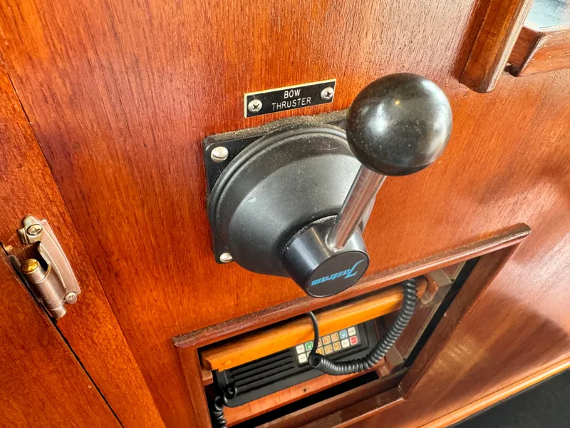 Slide: The Image of Bow thruster control on 1976 Nordlund 60 Motoryacht, featuring wooden paneling and communication device. - 36