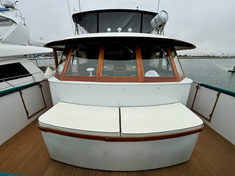Slide: The Image of 1976 Nordlund 60 Motoryacht with wooden accents and cushioned seating on deck. - 41