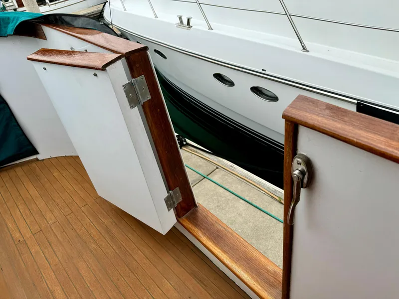 Slide: The Image of Nordlund 60 Motoryacht 1976, open wooden deck gate, docked beside another yacht. - 42