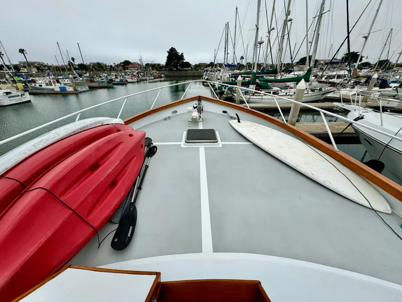 Slide: The Image of 1976 Nordlund 60 Motoryacht deck with kayaks and surfboard in marina. - 44