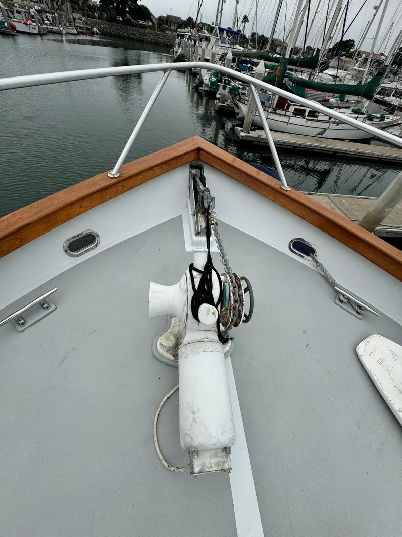 Slide: The Image of Bow of 1976 Nordlund 60 Motoryacht with anchor chain, docked in marina. - 45