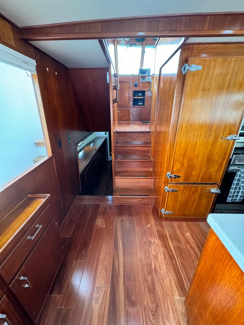 Slide: The Image of Interior of 1976 Nordlund 60 Motoryacht with wooden cabinetry and stairs. - 5