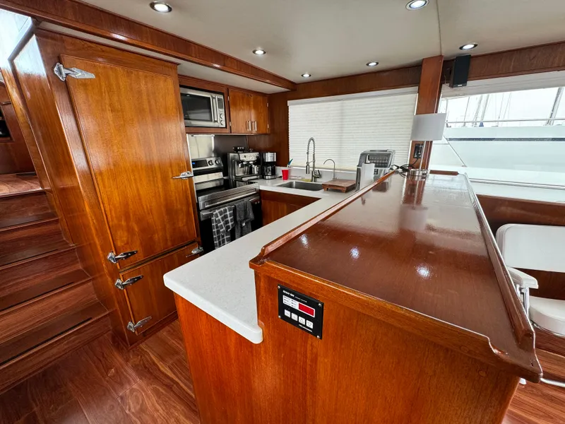 Slide: The Image of Interior of 1976 Nordlund 60 Motoryacht with modern kitchen and wooden cabinetry. - 6
