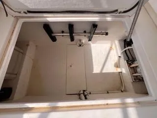 Slide: The Image of 2005 Contender 35 Side Console storage compartment with open hatch. - 11