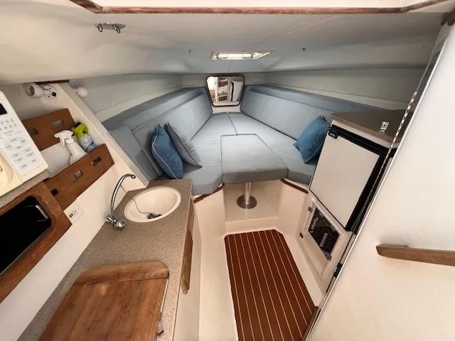 Slide: The Image of 2005 Contender 35 Side Console interior with kitchenette, seating, and wood accents. - 14