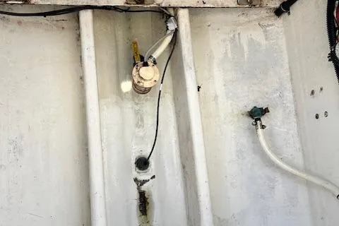 Slide: The Image of 2005 Contender 35 Side Console boat interior with visible wiring and plumbing. - 19