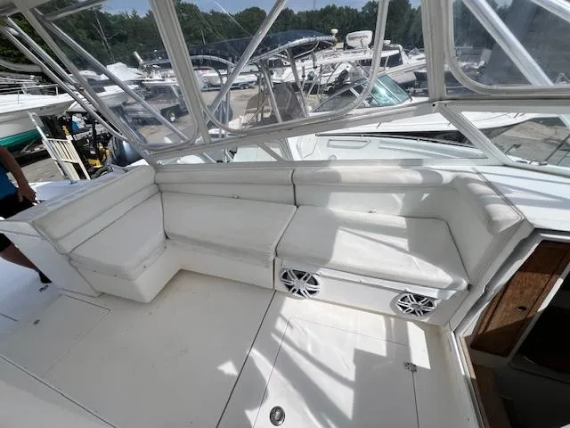 Slide: The Image of 2005 Contender 35 Side Console boat with white seating and clear canopy. - 9