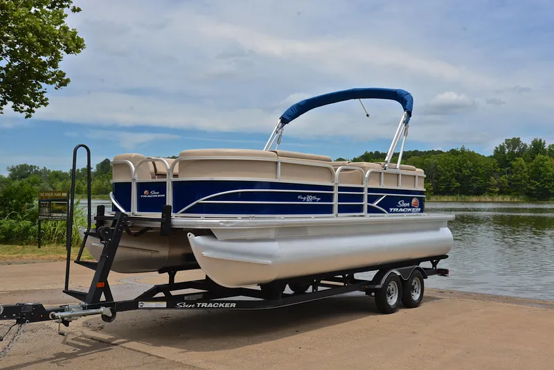 Slide: The Image of 2018 Sun Tracker Party Barge 20 DLX pontoon boat on trailer by a lake. - 10