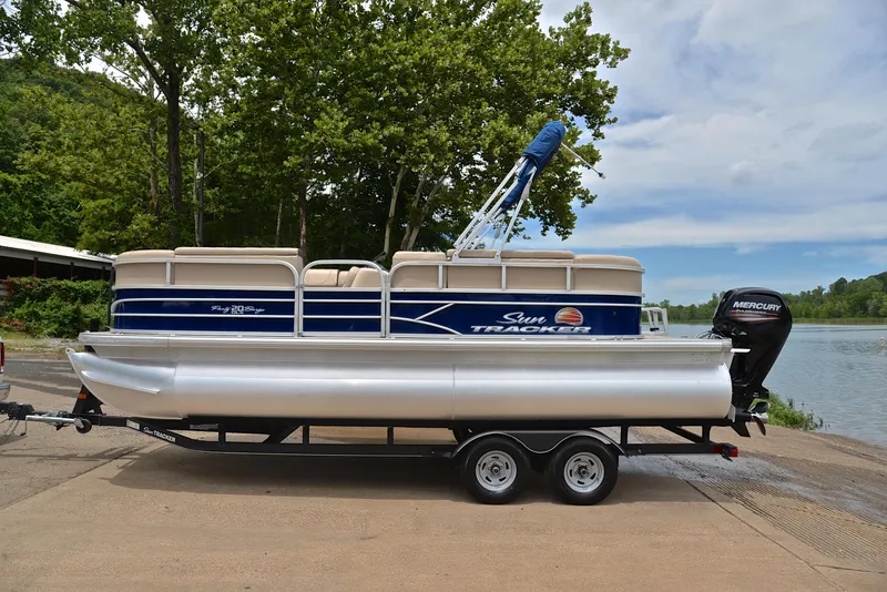 Slide: The Image of 2018 Sun Tracker Party Barge 20 DLX pontoon boat on trailer by a lake. - 11