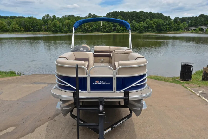 Slide: The Image of 2018 Sun Tracker Party Barge 20 DLX pontoon boat on a trailer by a lake. - 17