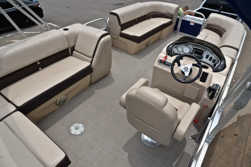Slide: The Image of 2018 Sun Tracker Party Barge 20 DLX pontoon boat interior with beige seating and steering console. - 19