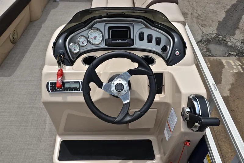 Slide: The Image of 2018 Sun Tracker Party Barge 20 DLX helm with steering wheel and control panel. - 24