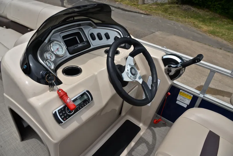Slide: The Image of 2018 Sun Tracker Party Barge 20 DLX steering console with gauges and controls. - 25