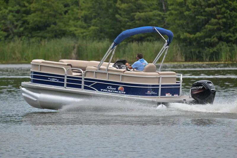 Slide: The Image of 2018 Sun Tracker Party Barge 20 DLX pontoon boat cruising on a lake. - 4