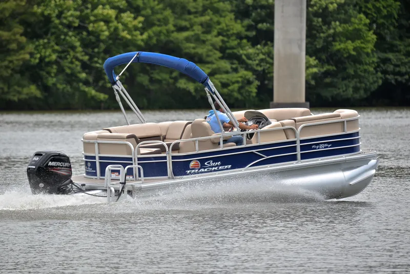 Slide: The Image of 2018 Sun Tracker Party Barge 20 DLX pontoon boat cruising on a lake. - 5