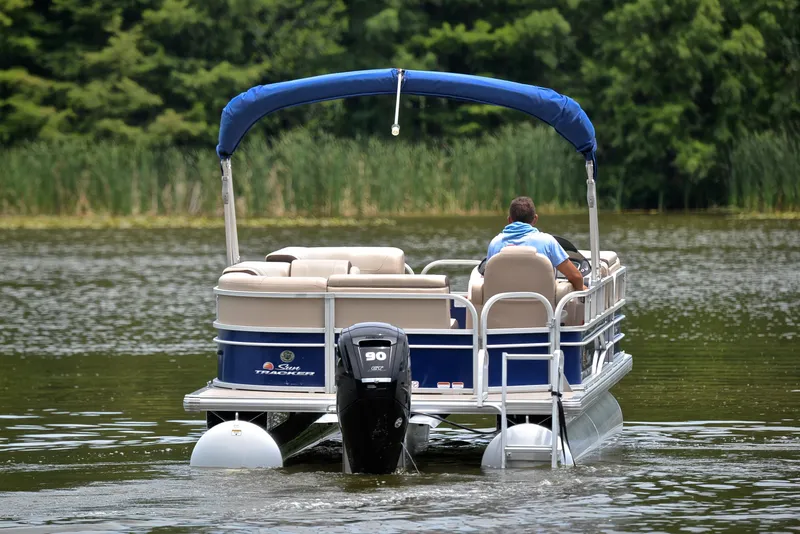 Slide: The Image of 2018 Sun Tracker Party Barge 20 DLX pontoon boat cruising on a lake. - 7