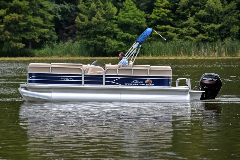 Slide: The Image of 2018 Sun Tracker Party Barge 20 DLX pontoon boat cruising on a lake. - 8