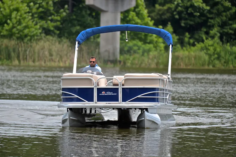 Slide: The Image of 2018 Sun Tracker Party Barge 20 DLX pontoon boat cruising on a lake. - 9