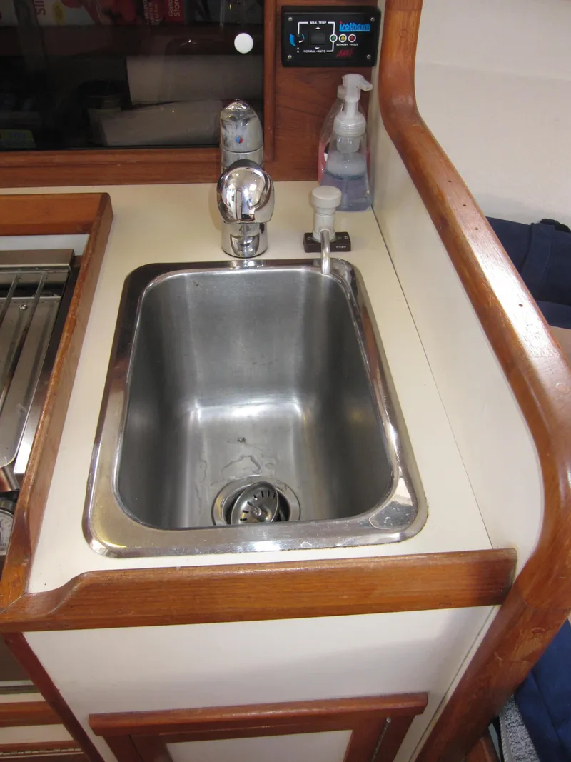 Slide: The Image of 1990 Blue Seas 31 Hardtop Cruiser kitchen sink with faucet and soap dispenser. - 11