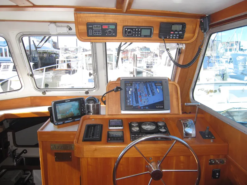 Slide: The Image of Interior helm of a 1990 Blue Seas 31 Hardtop Cruiser with navigation equipment. - 16