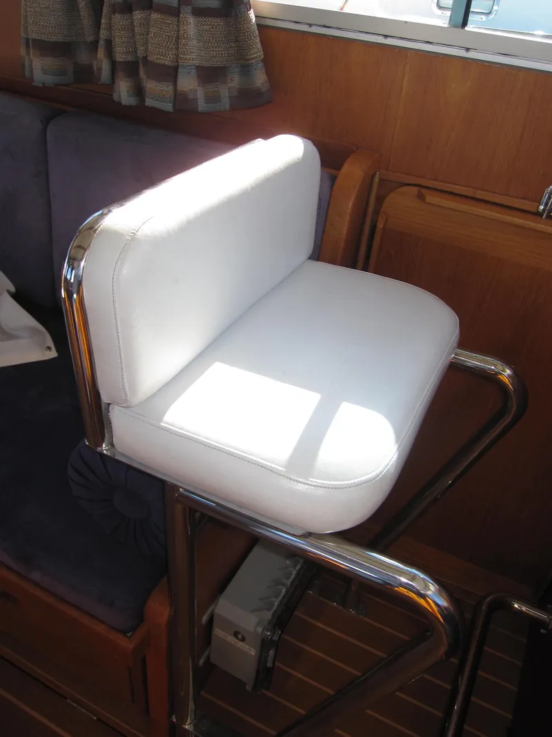 Slide: The Image of White cushioned seat in 1990 Blue Seas 31 Hardtop Cruiser boat interior. - 21
