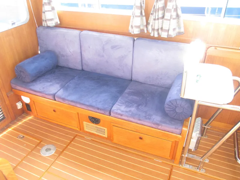 Slide: The Image of Interior seating of a 1990 Blue Seas 31 Hardtop Cruiser with blue cushions. - 25