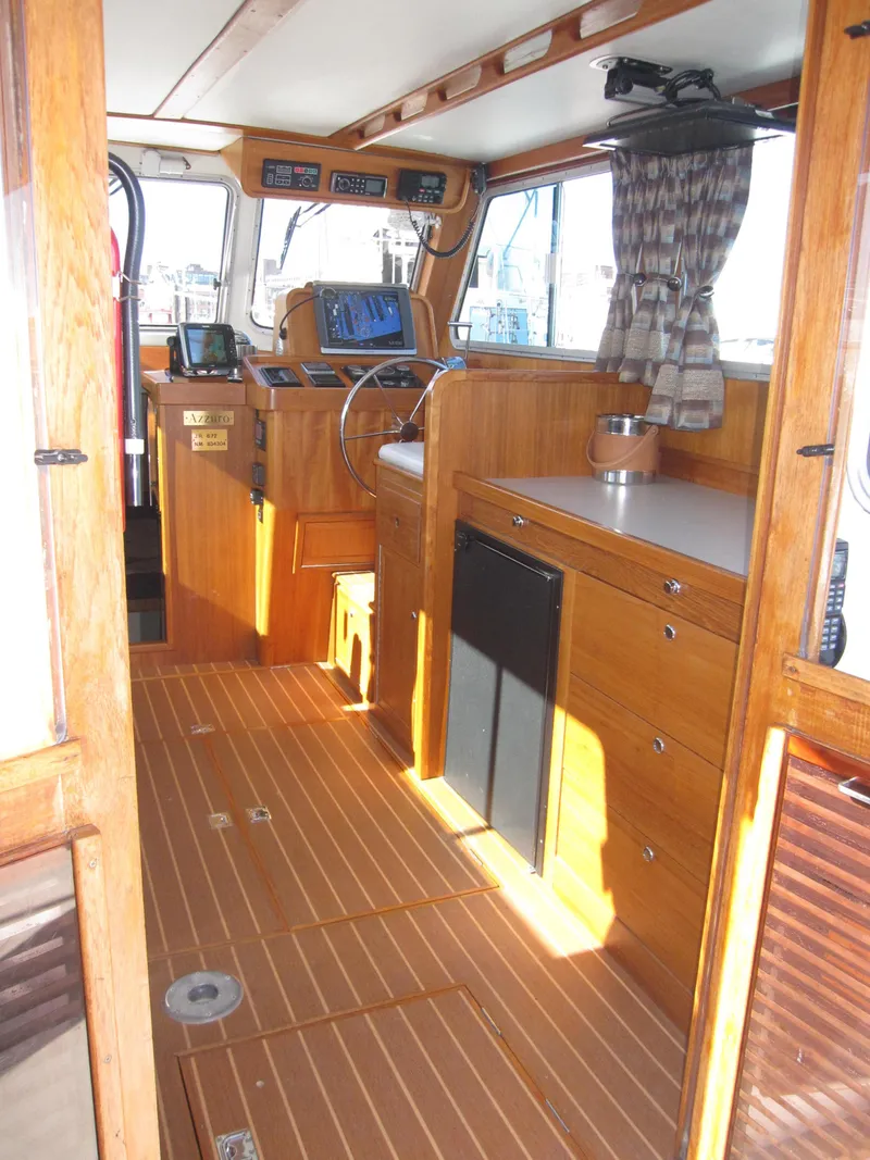 Slide: The Image of Interior of 1990 Blue Seas 31 Hardtop Cruiser with wooden cabinetry and modern navigation equipment. - 27