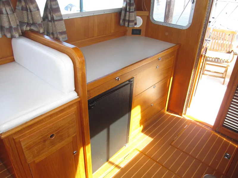 Slide: The Image of Interior of 1990 Blue Seas 31 Hardtop Cruiser with wooden cabinetry and mini-fridge. - 28